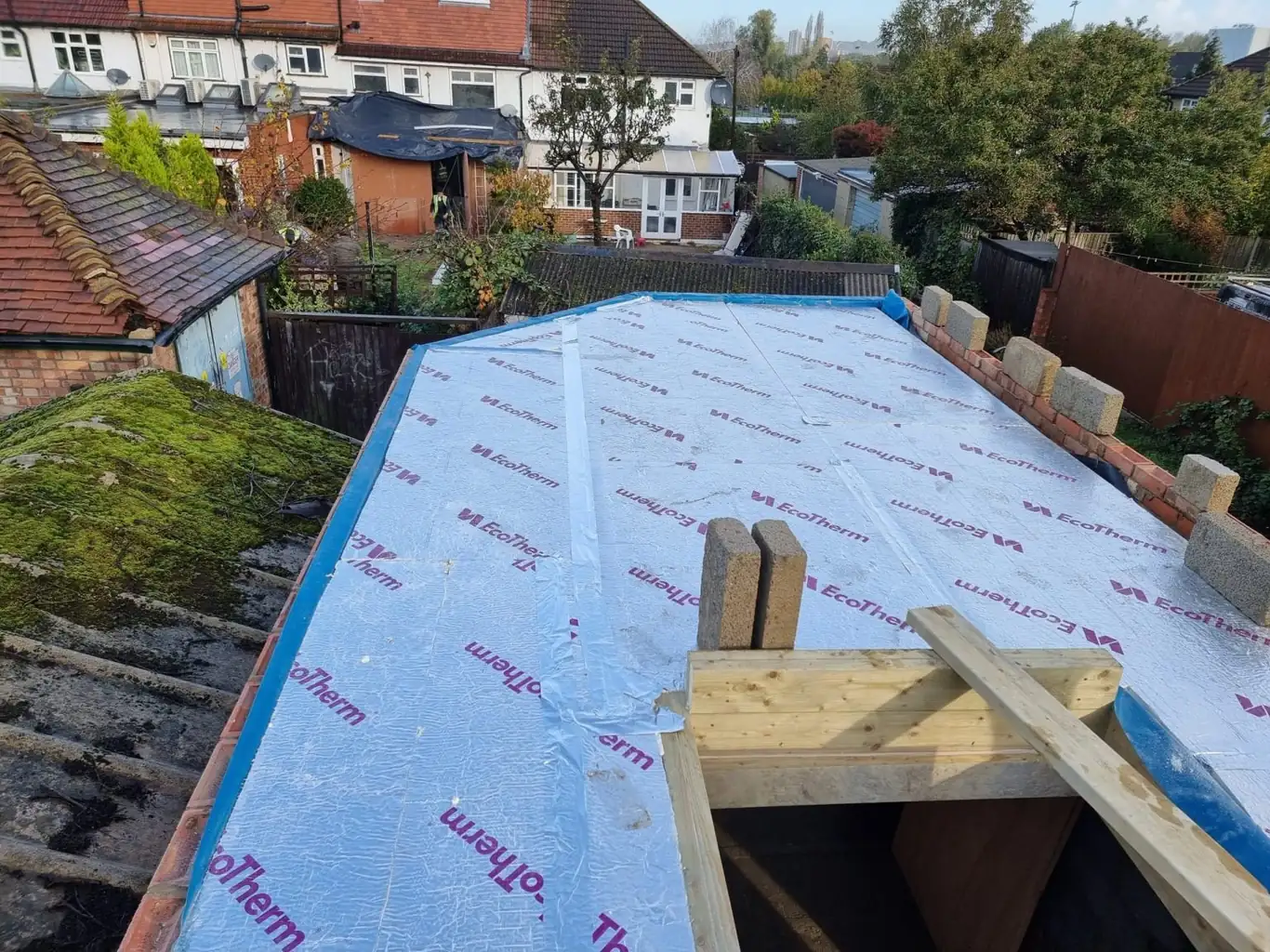 Warm flat roof being insulated with EcoTherm boards on a London extension, a Build Team project