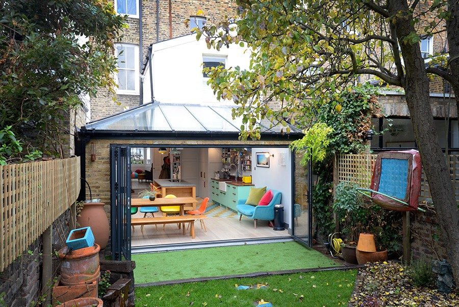 Glazed pitched-roof rear extension on a London period terrace with bifold doors open to the garden, a Build Team project