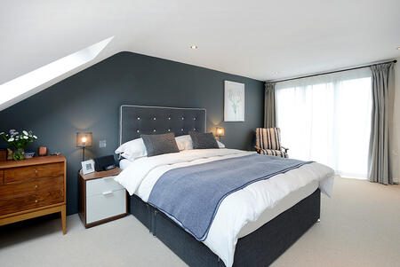 Finished loft bedroom interior in a London hip-to-gable conversion