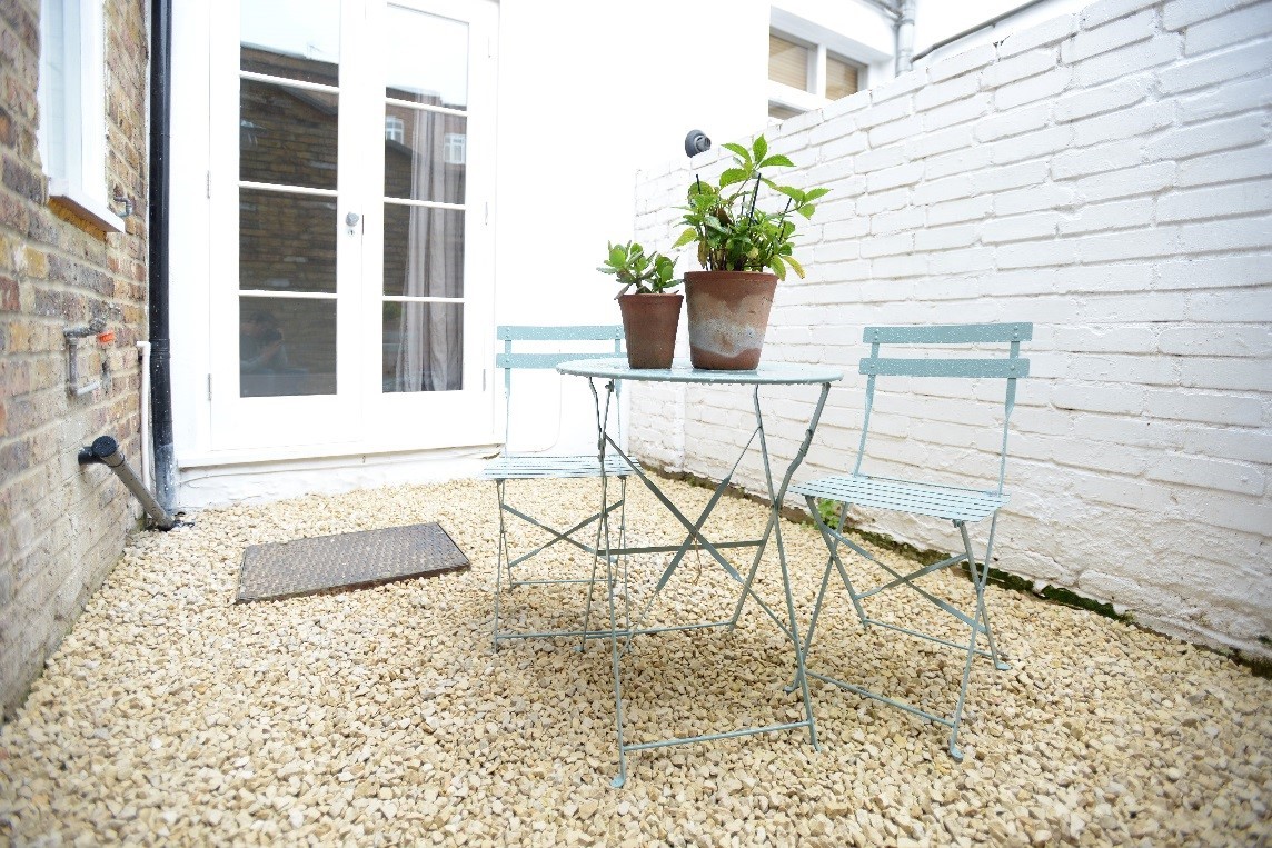 Painted brick party wall in a small courtyard