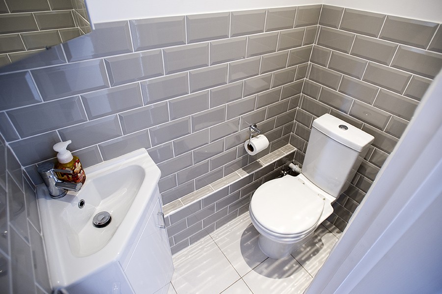 Small cloakroom WC with grey metro tiles, a corner basin and a toilet, Addison Road