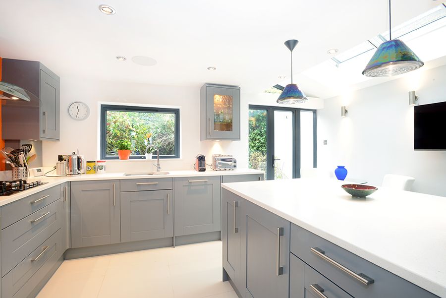 Silver Bezel Downlights Complementing the Kitchen Extension's Blue and Grey Theme
