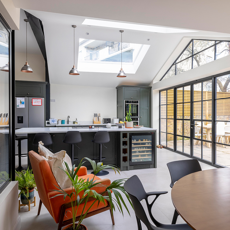 Rear elevation of the Victorian terrace after the extension, with black Crittall doors and a gable window