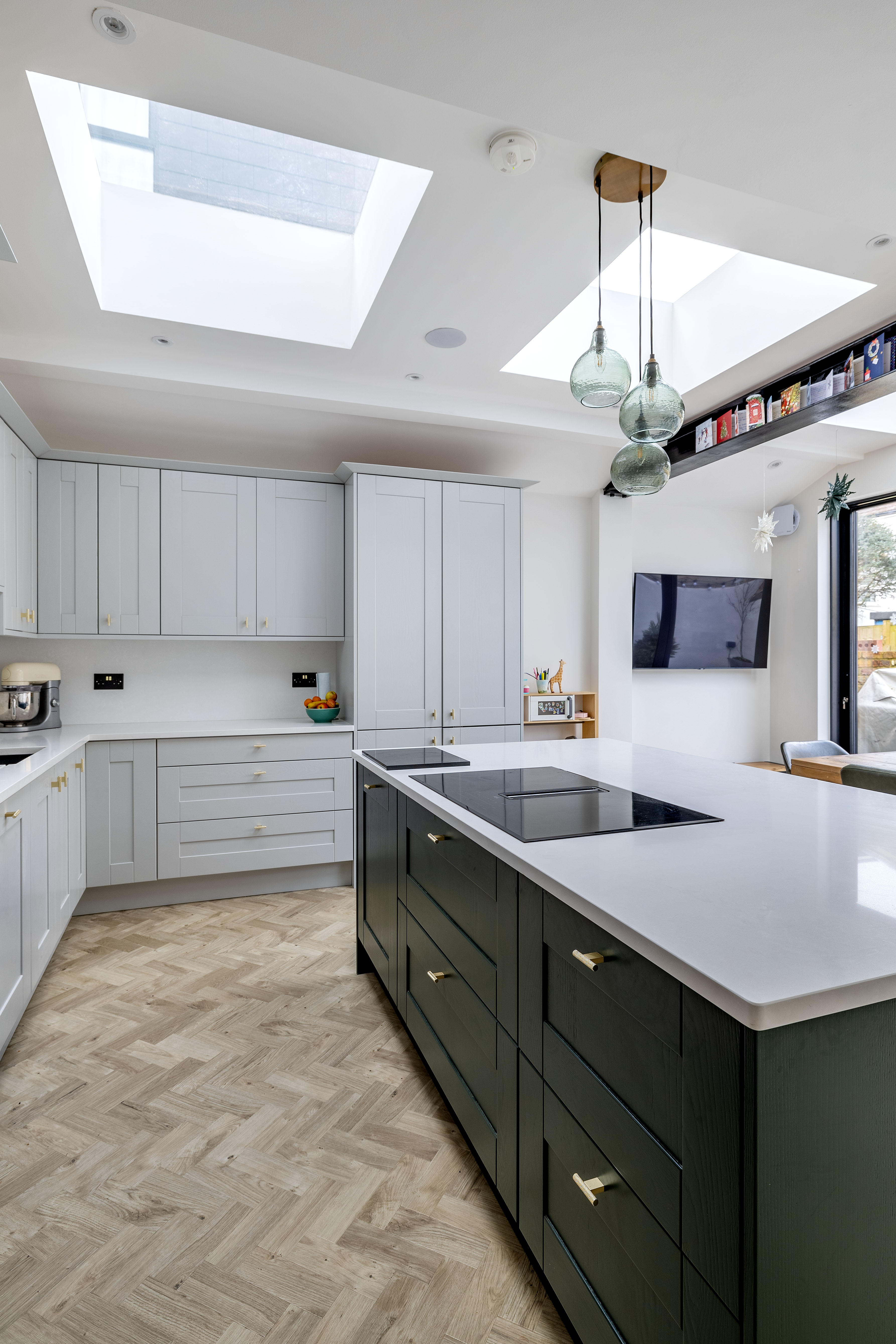 Interior showing exposed steel beam, island and skylights at Heber Road